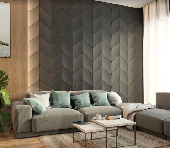 Charcoal chevron upholstered wall panel behind a sofa