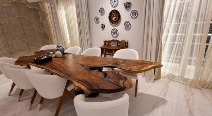 Live-edge solid wood dining table with white chairs