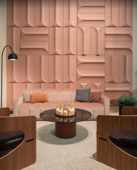 Blush terracotta sculpted panel wall behind a lounge seating area by Bhumi Decor