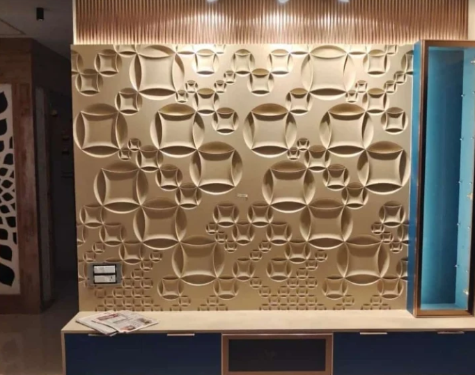 Gold sculpted circular 3D panel media wall by Bhumi Decor